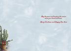Inside of a holiday greeting card with a light blue wash background and red script message 'May the peace and beauty of the season warm your heart and home. Merry Christmas and Happy New Year'.