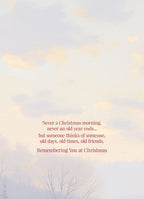 Close-up of a greeting card interior with the heartfelt text: "Never a Christmas morning, never an old year ends... but someone thinks of someone, old days, old times, old friends. Remembering You at Christmas" against a soft, light background.