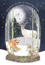 Enchanting snow globe greeting card featuring a majestic white deer and a curious fox in a snowy forest under a full moon and twinkling stars, perfect for seasonal wishes.