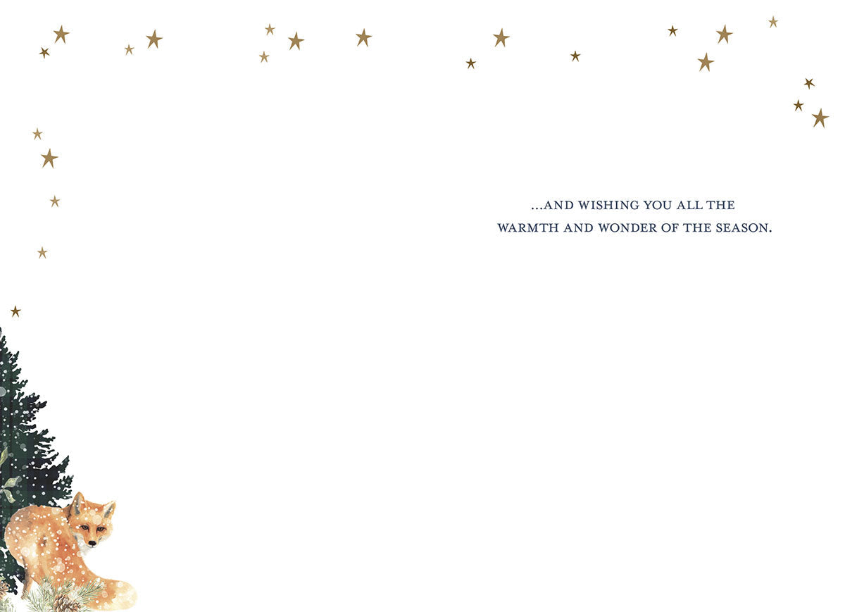 Inside of a serene winter greeting card with a small fox peeking from a snowy evergreen tree, featuring the heartfelt message: '...AND WISHING YOU ALL THE WARMTH AND WONDER OF THE SEASON.'
