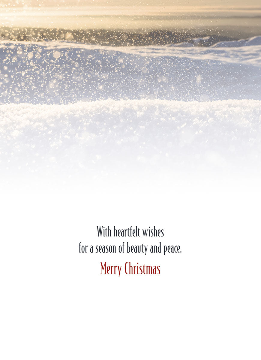 Inside of a seasonal greeting card featuring the message 'With heartfelt wishes for a season of beauty and peace. Merry Christmas' on a white background with subtle snowy top.
