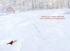 Inside of a serene winter greeting card showcasing a snowy field and a red cardinal. Text wishes 'Wishing you a season filled with merry moments and happy hearts!'.