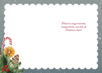 Inside view of a heartfelt holiday greeting card with a scalloped white border and a snow-dusted gray background. The bottom left corner showcases a decorative candy cane, dried orange, and green foliage. The interior message reads: 'Here's to cozy moments, happy hearts, and lots of Christmas cheer!'