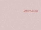 Interior of a heartfelt holiday greeting card featuring a light pink speckled background and elegant red script message for a joyous celebration.