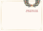 Inside of a holiday greeting card, showing a blank space for a personal message and the pre-printed text 'WISHING YOU PEACE, JOY AND ALL THE MAGIC OF THE SEASON' in red, with a gold border and a partial festive wreath design.