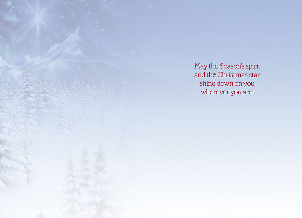 Inside of a holiday greeting card with a serene snowy background and heartfelt message: 'May the Season's spirit and the Christmas star shine down on you wherever you are!'