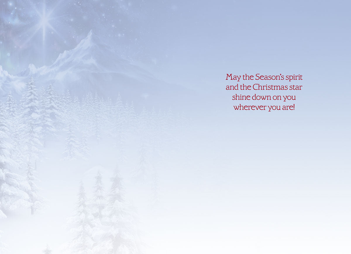 Inside of a holiday greeting card with a serene snowy background and heartfelt message: 'May the Season's spirit and the Christmas star shine down on you wherever you are!'