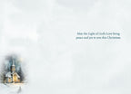 Interior of a religious Christmas greeting card with a serene light blue background, a small vignette of a snowy church scene on the left, and elegant text on the right: 'May the Light of God's Love bring peace and joy to you this Christmas.'