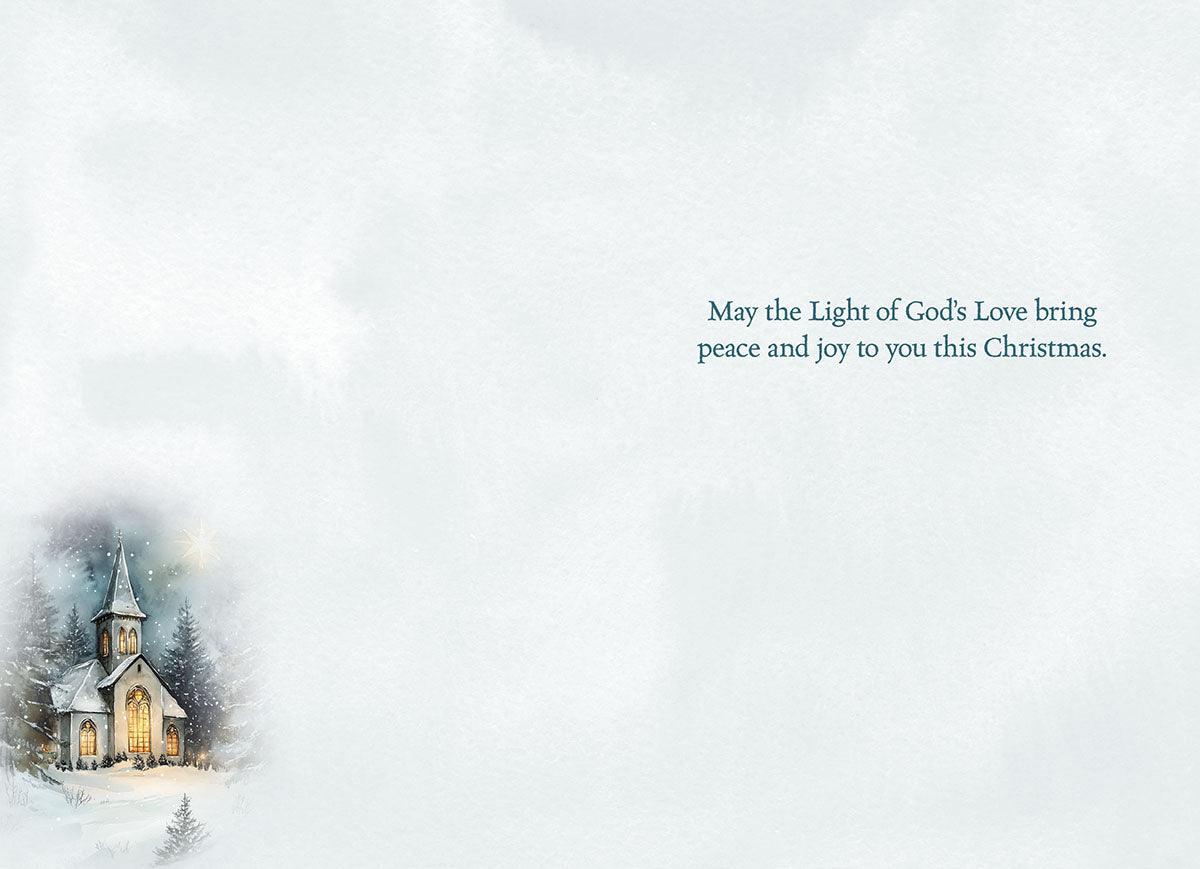 Interior of a religious Christmas greeting card with a serene light blue background, a small vignette of a snowy church scene on the left, and elegant text on the right: 'May the Light of God's Love bring peace and joy to you this Christmas.'
