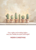 Inside of a modern holiday greeting card featuring potted cacti adorned with subtle string lights above, with a heartfelt message: "Cozy nights and twinkling lights—may your holiday be joyful and bright! MERRY CHRISTMAS."