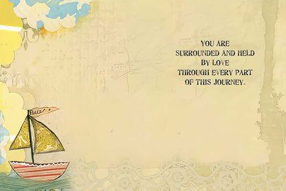 Inside of an encouraging greeting card featuring 'You are surrounded and held by love through every part of this journey.' text and a sailboat.