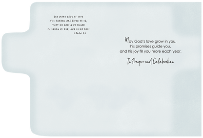 Inside of a baptism card with 1 John 3:1 scripture and a heartfelt blessing: 'May God's love grow in you, his promises guide you... In Prayer and Celebration'.