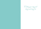 Inside of a pastel blue and white Easter card, featuring a heartfelt message 'Wishing you every good thing and lots of it!' in elegant script.