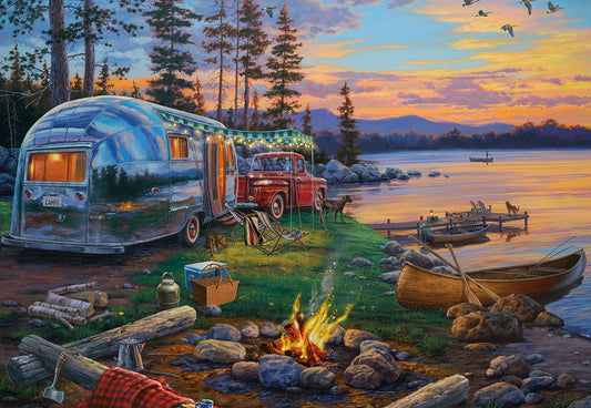 Panoramic view of a vintage silver camper and red truck by a lake at sunset, with a campfire and canoe on Father's Day.
