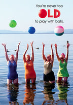 Funny birthday card for her, featuring four laughing senior women in swimsuits reaching for colorful beach balls in water, with the text 'You're never too OLD to play with balls.'