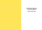 Inside of a humorous greeting card with text 'HOPE TODAY FINDS YOU LIVING THE DREAM! HAPPY BIRTHDAY' on a white background with a yellow stripe.