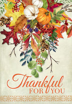 Thanksgiving greeting card front featuring vibrant autumn cornucopia with pumpkins, gourds, berries, and colorful fall leaves on a rustic background, with 'Thankful For You' text.