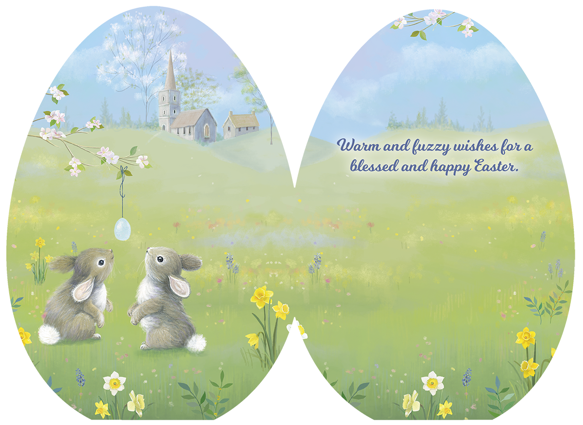 Open Easter greeting card revealing the sweet message 'Warm and fuzzy wishes for a blessed and happy Easter.' alongside the charming illustration of two bunnies in a spring meadow with a church and hanging egg design.