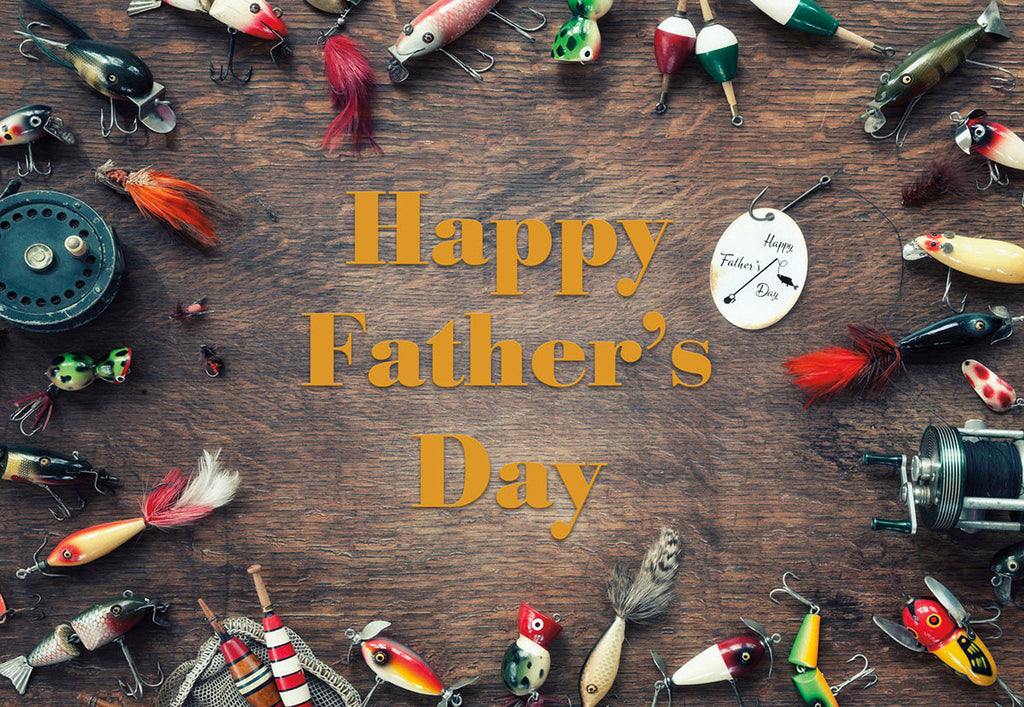 Flat lay of vintage fishing lures, bobbers, and reels framing 'Happy Father's Day' text on a rustic wood background, perfect for outdoorsy dads.
