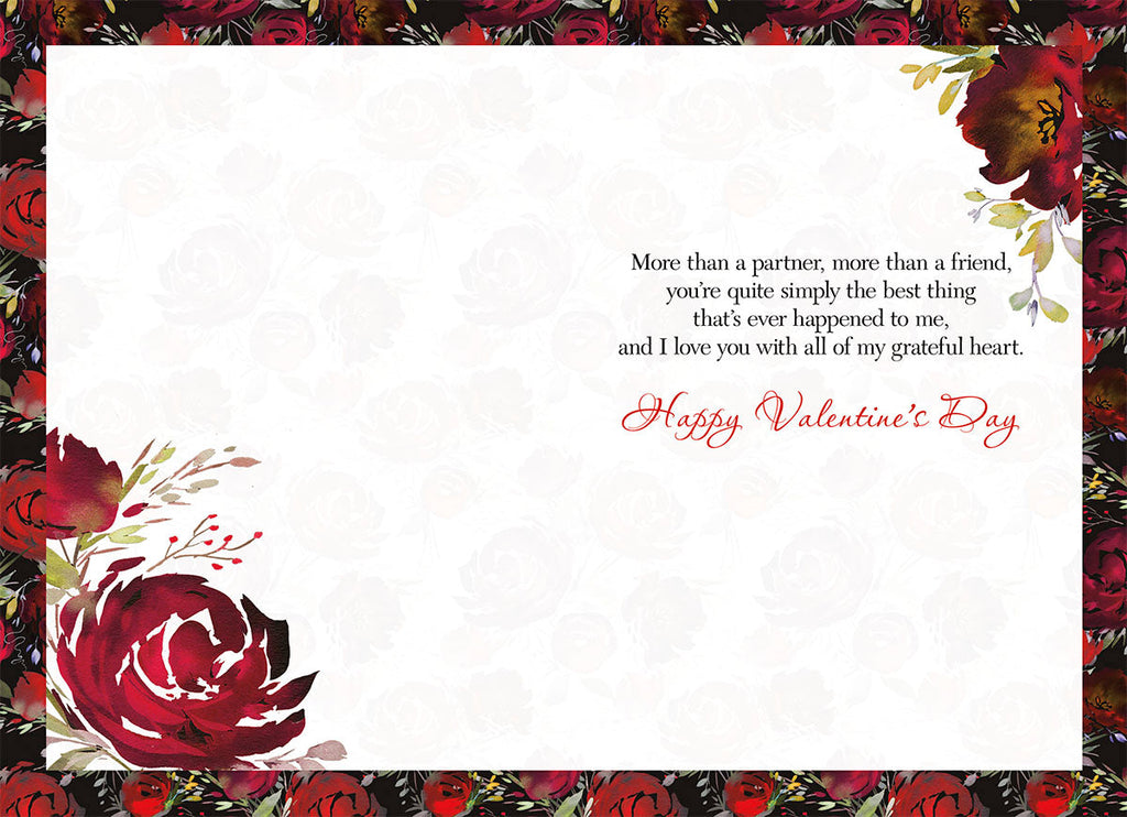 Inside of a heartfelt greeting card, displaying a loving message framed by a border of watercolor red roses and green leaves: 'More than a partner, more than a friend, you're quite simply the best thing that's ever happened to me, and I love you with all of my grateful heart. Happy Valentine's Day'.