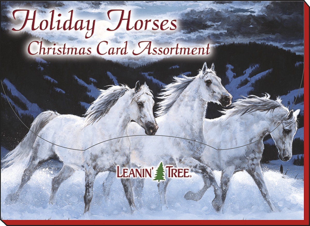 Box cover for 'Holiday Horses Christmas Card Assortment' by Leanin' Tree, showing three powerful white horses galloping through a snowy landscape.