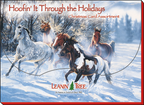 Box cover for 'Hoofin' It Through the Holidays' horse-themed card assortment, featuring several horses galloping through deep snow in a winter forest, with the Leanin' Tree logo visible.