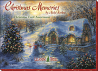 Box cover for 'Christmas Memories by Nicky Boehme Christmas Card Assortment' by Leanin' Tree, showcasing a glowing snow-covered cottage and festive tree.