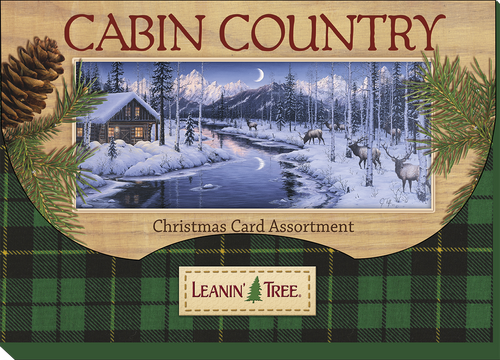Leanin' Tree Cabin Country Christmas Card Assortment box cover with a moonlit snowy cabin, river, deer, pinecone, and green plaid design.
