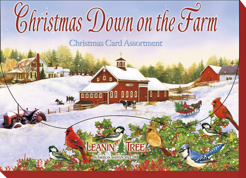 Front of a 'Christmas Down on the Farm' greeting card by Leanin' Tree, illustrating a cozy red barn, cattle, horse-drawn sleigh, and colorful birds in a snowy winter scene.
