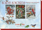 Product packaging for 'Holiday Songbirds Christmas Card Assortment by Greg Giordano' from Leanin' Tree. The box displays three card designs: birds on a red Adirondack chair, birds around a green birdhouse, and cardinals in front of a snowy house, set against a background of falling snow.