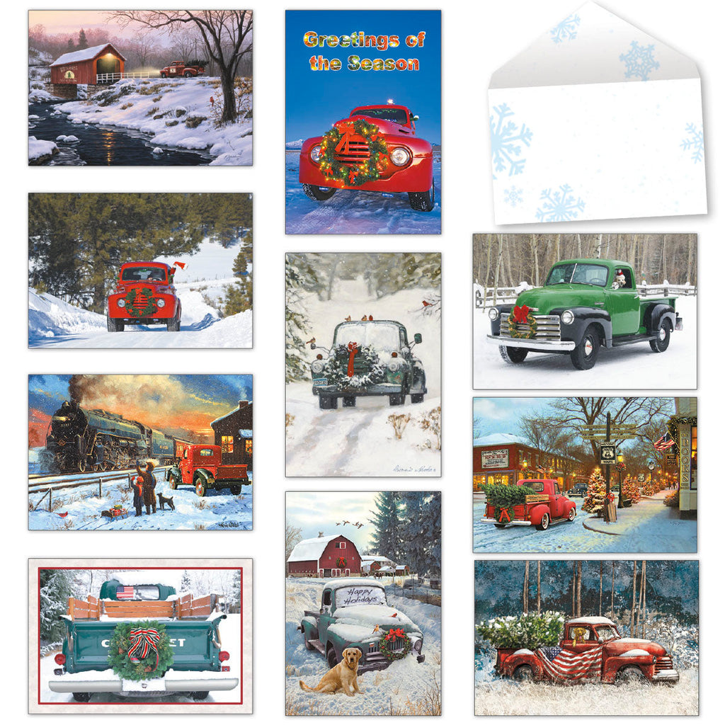 Assortment of festive holiday greeting cards featuring vintage trucks, a steam train, and snowy winter landscapes with a blank snowflake envelope.