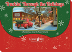 Front packaging for 'Truckin' Through the Holidays' Christmas card assortment, showing a red vintage truck with a Christmas tree in a decorated town square, surrounded by snowflakes.