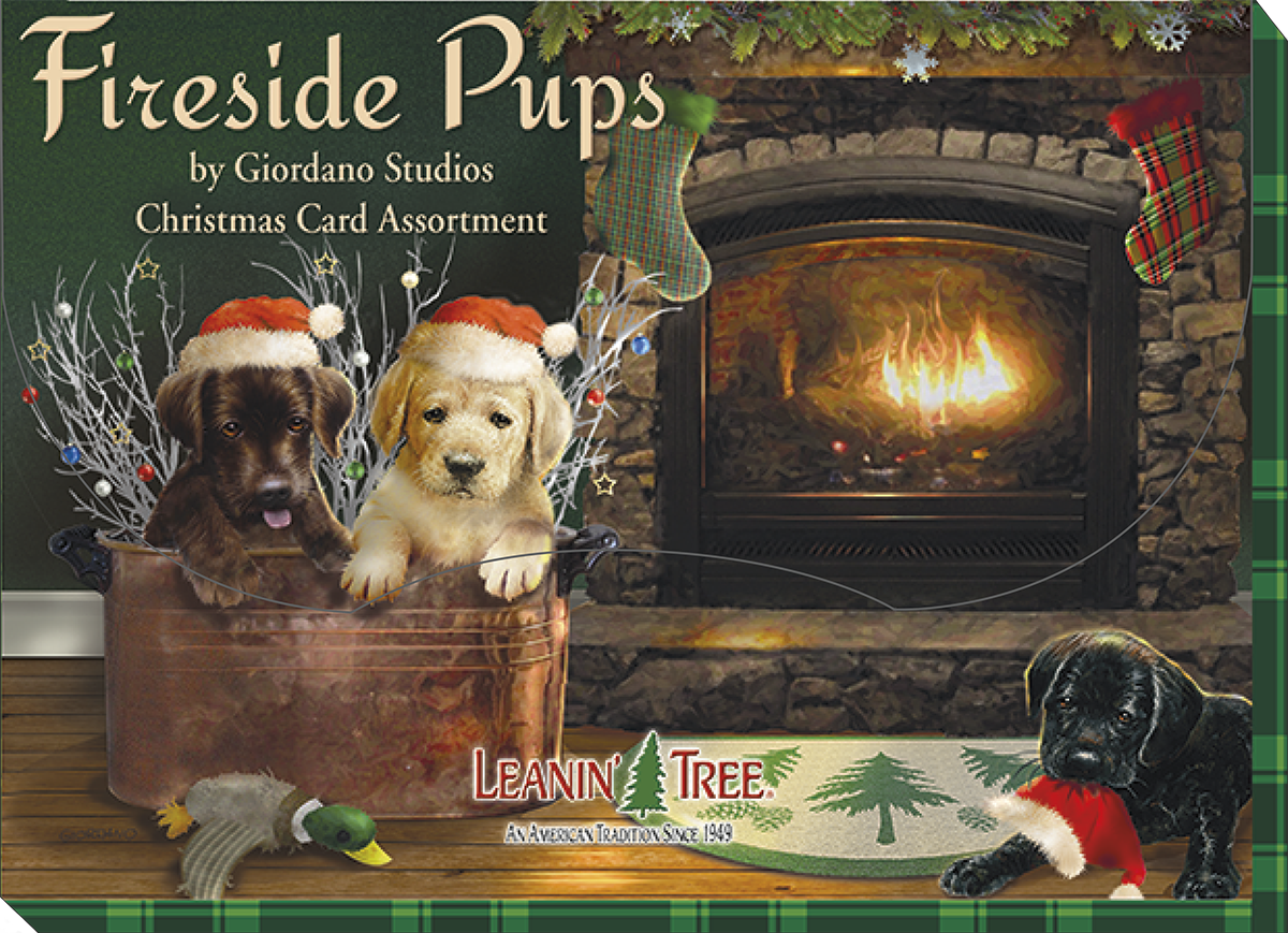 Fireside Pups holiday greeting card assortment box by Giordano Studios, featuring two puppies in a copper bucket by a fireplace, with a black lab puppy in a Santa hat on a rug.