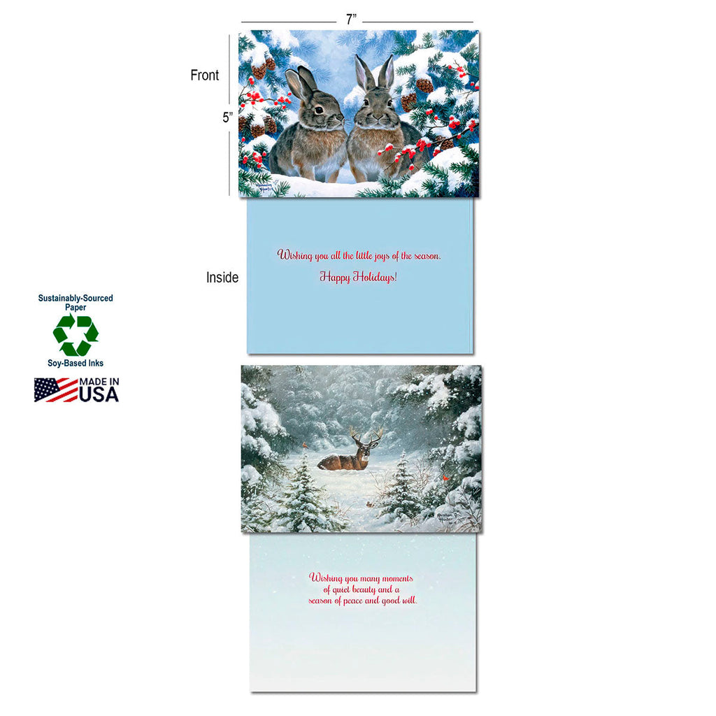 Two Leanin' Tree Christmas cards displayed open: one with two rabbits on the front and 'Happy Holidays!' inside; another with a deer in snow on the front. Features 'Sustainably-Sourced Paper', 'Soy-Based Inks', and 'Made in USA' labels.