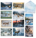 Assortment of nature-themed holiday greeting cards featuring deer and elk in snowy winter landscapes, with a decorative blue snowflake envelope.