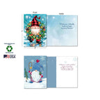 A close-up view of two gnome holiday cards, one with a gnome in a wreath, showing the front and inside messages, alongside "Sustainably-Sourced Paper," "Soy-Based Inks," and "Made in USA" labels.
