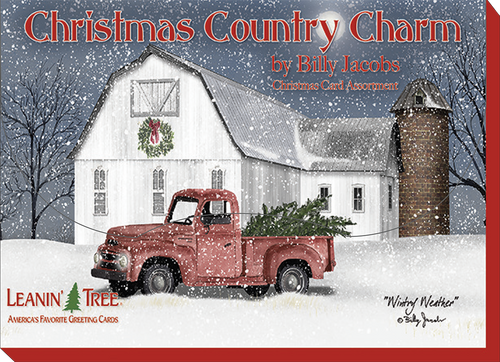 Front cover of a festive country winter greeting card by Billy Jacobs, showing a vintage red pickup truck carrying a freshly cut tree in front of a white barn during snowfall.