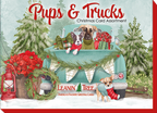 Leanin' Tree Pups & Trucks Christmas Card Assortment box cover with two dogs in a light blue vintage pickup truck adorned with holiday garland and presents, surrounded by snowy evergreens.