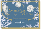 Retail packaging for coastal holiday greeting card assortment, blue with white coral and seashells, text 'Shellabrate The Season'.