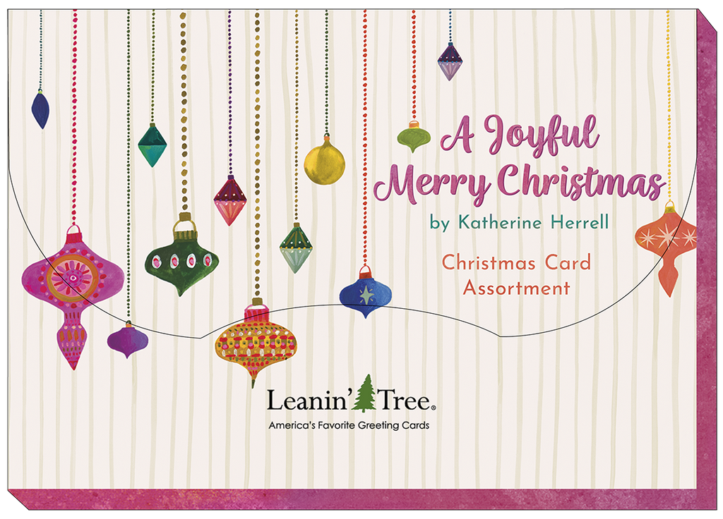Leanin' Tree 'A Joyful Merry Christmas' card assortment cover, featuring colorful hanging ornaments on a striped background, designed by Katherine Herrell.