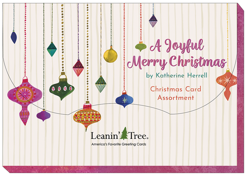 Leanin' Tree 'A Joyful Merry Christmas' card assortment cover, featuring colorful hanging ornaments on a striped background, designed by Katherine Herrell.