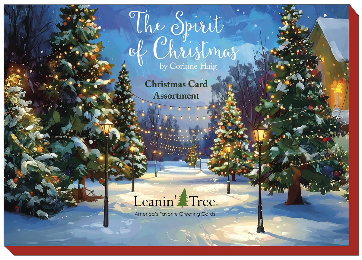 Cover of 'The Spirit of Christmas' greeting card assortment by Corinne Haig, showing a snowy path lined with glowing street lamps and decorated evergreen trees.