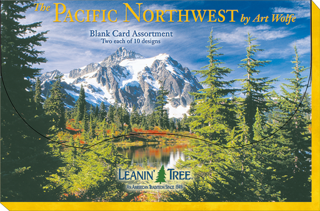 The front cover of 'The Pacific Northwest by Art Wolfe Blank Card Assortment' box, featuring a majestic snow-capped mountain, a serene lake, and tall evergreen trees under a blue sky.