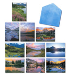 Assortment of blank greeting cards featuring various high country lake and mountain landscapes, with a blue envelope. Includes images of vibrant sunsets, reflective waters, and lush alpine scenery.