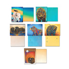 Arrangement of Micqaela Jones greeting cards displaying card fronts (white buffalo, grizzly bear, sleeping bison) and their blank colored interiors, part of the animal art assortment.