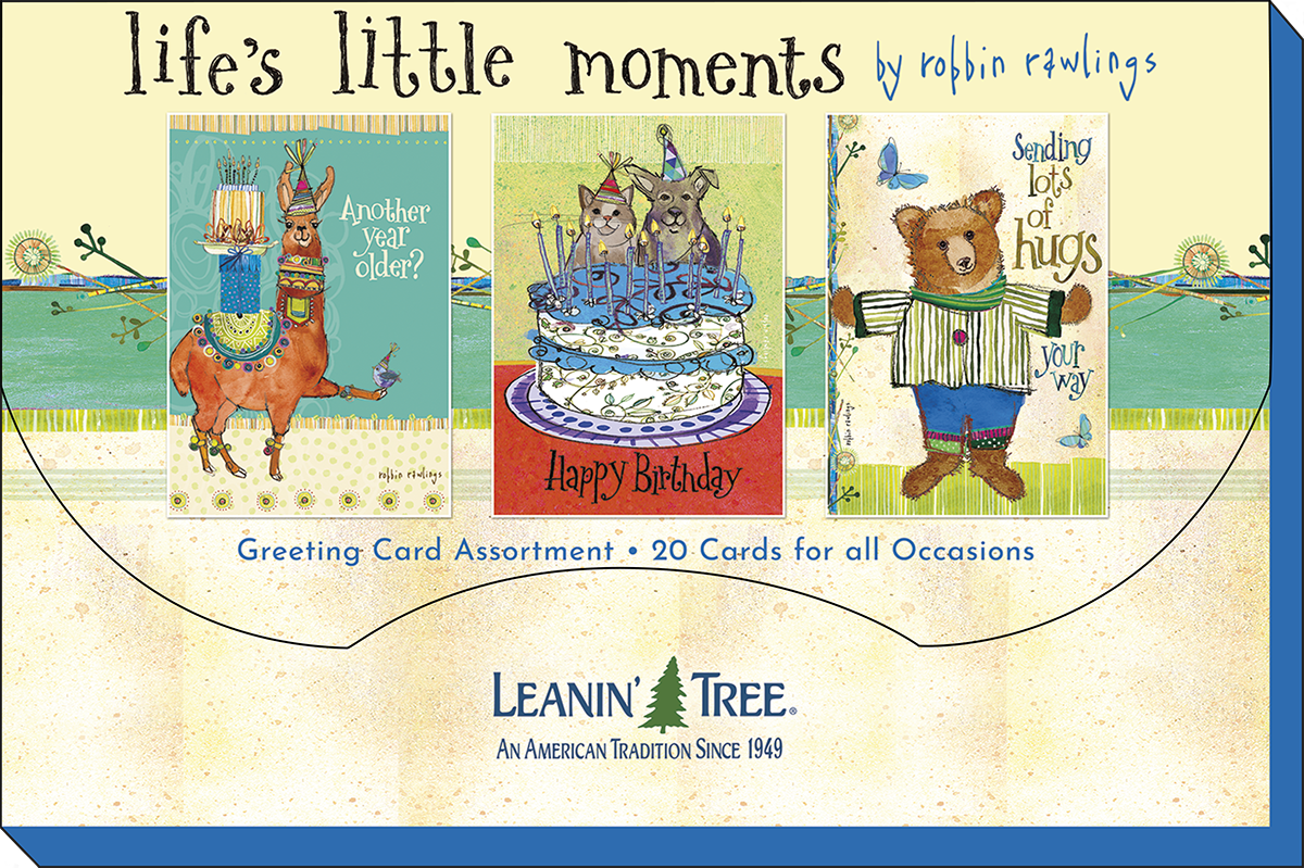 Packaging for 'Life's Little Moments' greeting card assortment, featuring three sample cards: a birthday llama, festive dogs/cats on a cake, and a bear sending hugs.