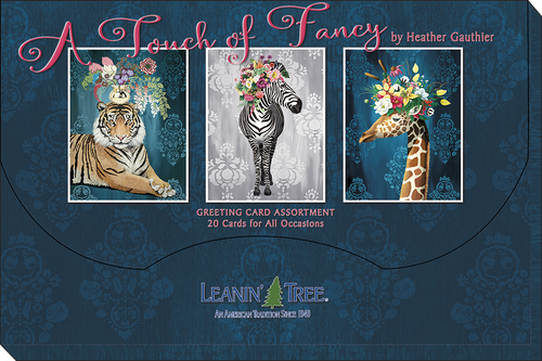 Dark blue packaging box for 'A Touch of Fancy by Heather Gauthier' greeting card assortment, featuring three framed animal art cards: a tiger, a zebra, and a giraffe, all adorned with flowers, with the 'Leanin' Tree' logo at the bottom.