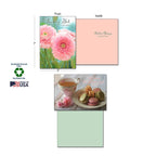 Close-up of a 'Thanking God' greeting card with pink gerbera daisies, showing inside message, product dimensions, and sustainability certifications like Soy-Based Inks and Made in USA.
