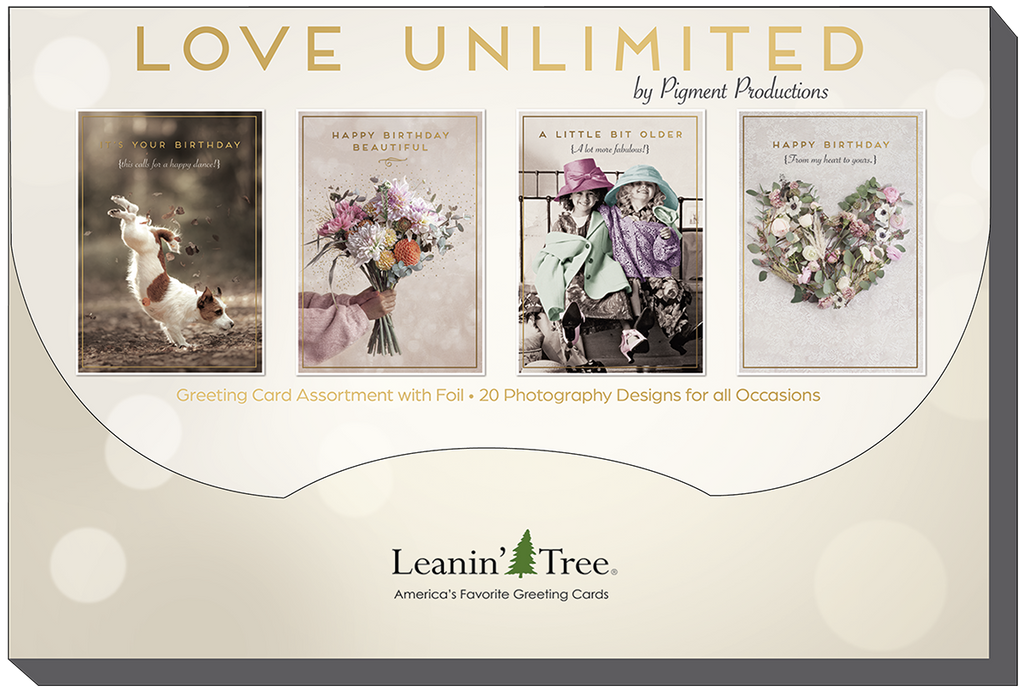 Brand banner 'LOVE UNLIMITED by Pigment Productions' showcasing four example greeting cards: 'It's Your Birthday' with a dog, 'Happy Birthday Beautiful' with flowers, 'A Little Bit Older' with two elderly women, and 'Happy Birthday' with a floral heart, highlighting '20 Photography Designs for all Occasions' from Leanin' Tree.