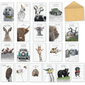A wide shot showing all 20 diverse greeting cards from the 'Life in Pencil' assortment by Shaun Vickers, featuring hand-drawn animals like a dog, parrot, goat, rabbit, highland cow, lion, pigs, giraffe, eagle, birds, bear, hedgehog, and a dachshund, along with nature and vehicle designs, plus a craft paper envelope. Ideal for all occasions.